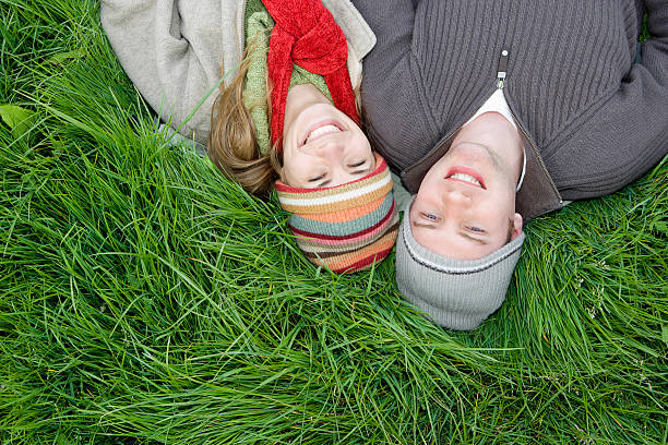istock Smiling Couple Relaxing On Grass 518915559
