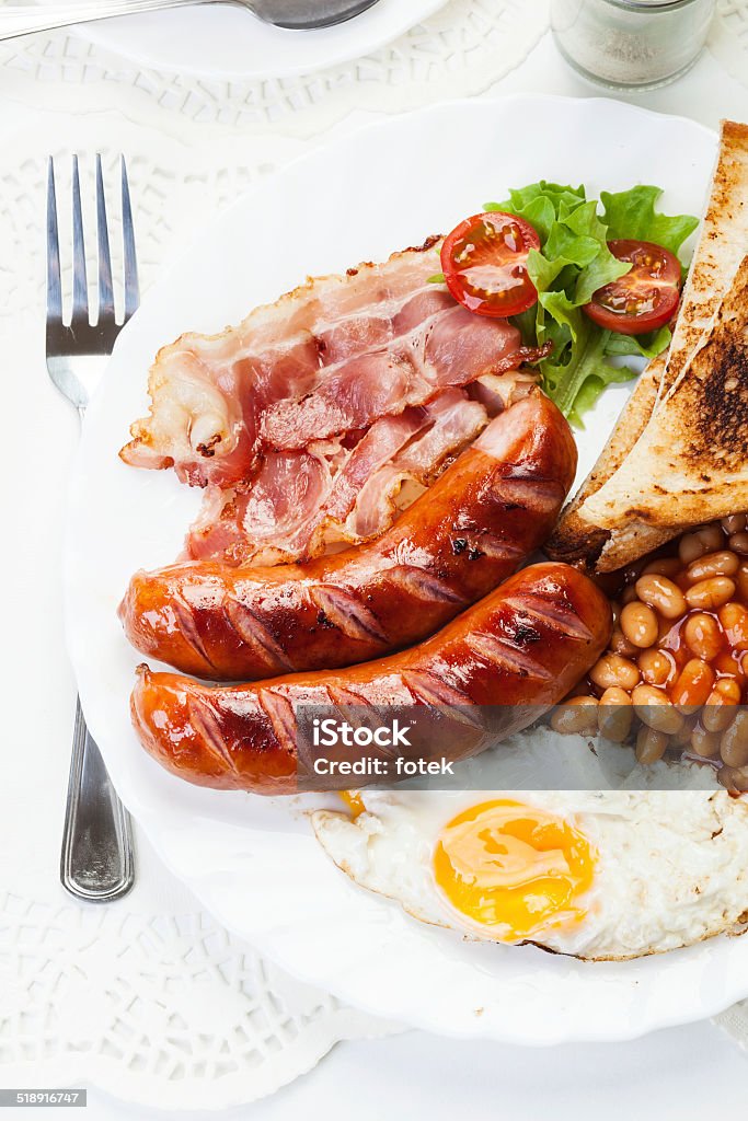 Desayuno inglés completo con tocino, salchichas, huevo frito y horneados - Foto de stock de Al horno libre de derechos