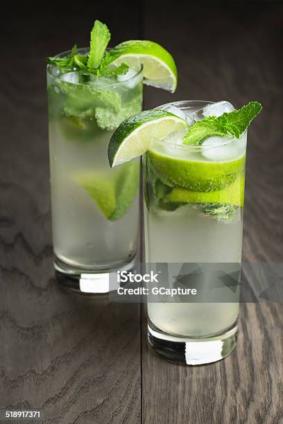 Two Mojito Cocktails On Old Oak Table Stock Photo - Download Image Now - Alcohol - Drink, Citrus Fruit, Close-up