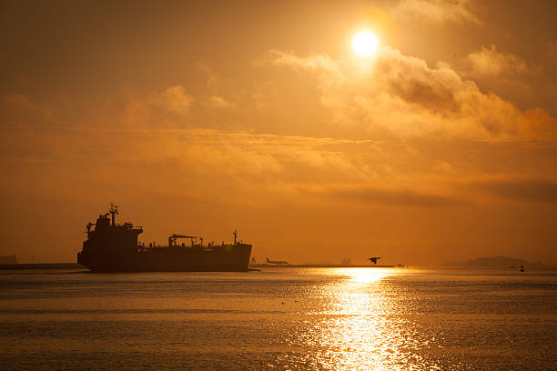 istock Tanker ship against sunrise in Boston Harbor 518925949