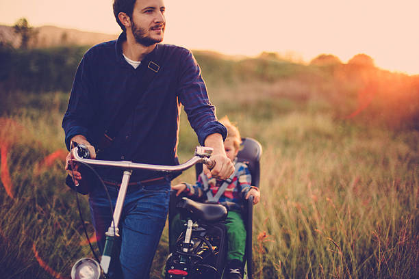 istock Father and baby cycling together 518927531