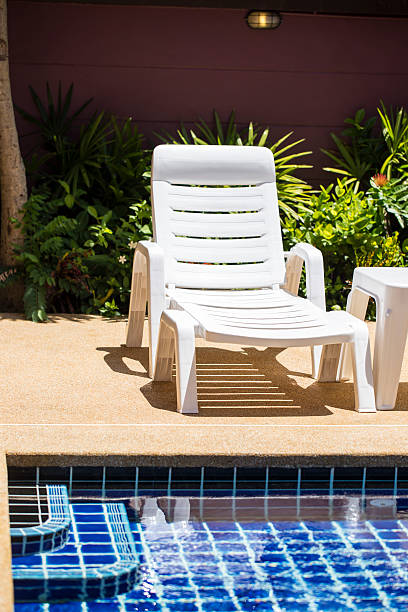 istock Swimming pool with lounge chair 518927819