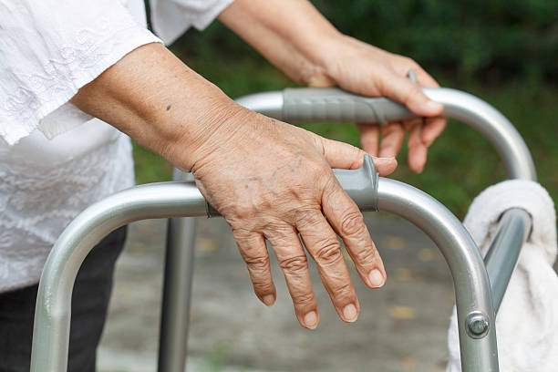 istock Senior woman using a walker cross street 518928853