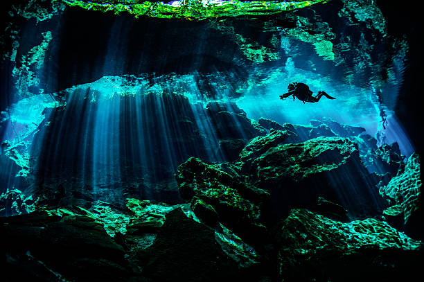 Amazing underwater locations Scuba diver exploring the underwater cenotes. cancun photos stock pictures, royalty-free photos & images