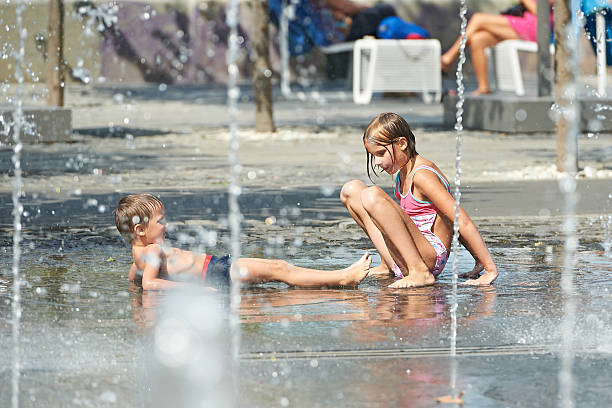 istock Children playing in puddle on hot weather 518930845