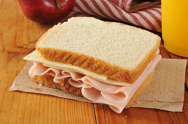 Ham and cheese sandwich a ham and cheese sandwich with orange juice and an apple ham and cheese sandwich stock pictures, royalty-free photos & images
