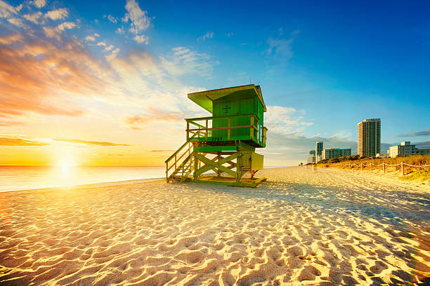 Miami South Beach sunrise Miami South Beach sunrise with lifeguard tower and coastline with colorful cloud and blue sky. south beach photos stock pictures, royalty-free photos & images