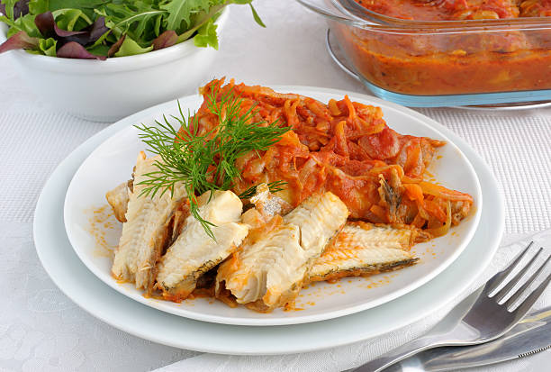 istock Baked fish in tomato sauce with vegetables 518931793