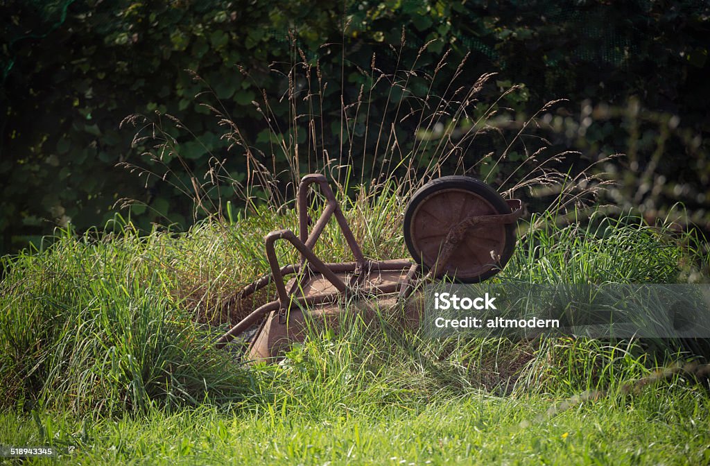 rusty wheelbarrow Old rusty wheelbarrow in the grass Autumn Stock Photo