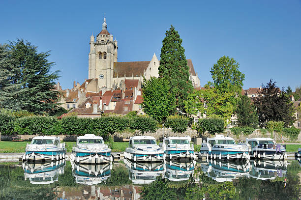 Dole and the Doubs River Collégiale de Notre-Dame at Dole (Jura, Franche-Comté, France) with at foreground the Doubs River and pleasure boats dole stock pictures, royalty-free photos & images