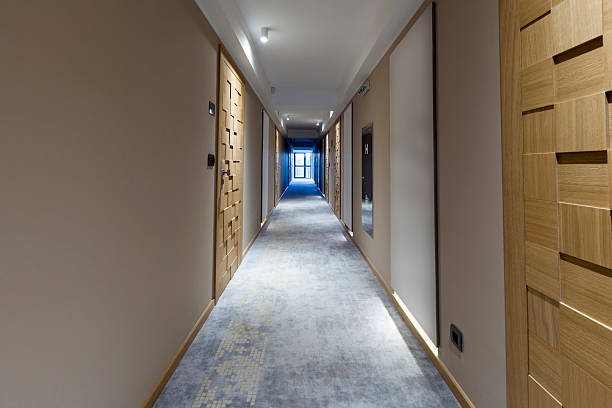istock Long corridor with wooden doors 518944785
