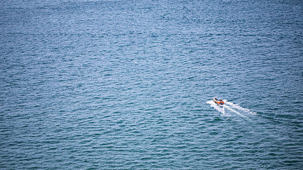 istock Lonely boat floating out into the open sea 518945925