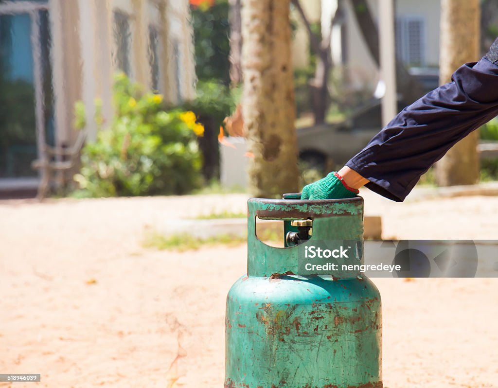 Demonstration of fire caused by gas canisters by hand Blowing Stock Photo