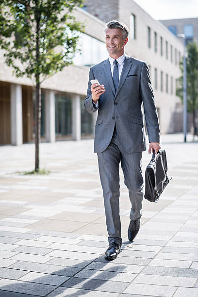 istock Business man holding mobile phone 518947325