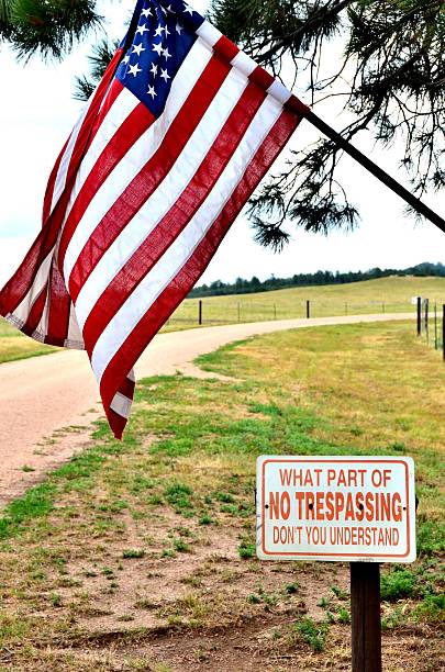 istock American Flag with no Trespassing Sign 518947841