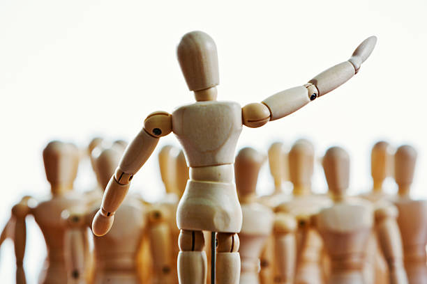 istock Puppet speaker, conductor, or preacher addressing lay figures 518948085