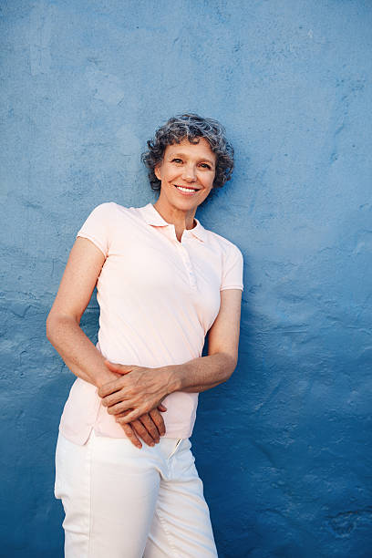 istock Relaxed mature lady leaning to a wall 518948872