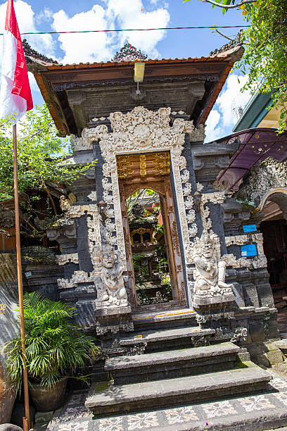 Hindu temple in Bali The door is fully decorated with oriental motifs and designs in gold. palazzo antico stock pictures, royalty-free photos & images
