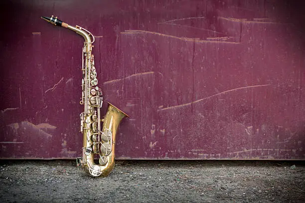 Jazz musical instrument saxophone with grungy street background