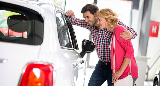 istock Young  couple chooses to buy a car 518949828