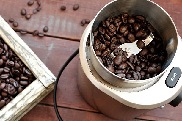 Electric coffee grinder with roasted coffee beans stock photo
