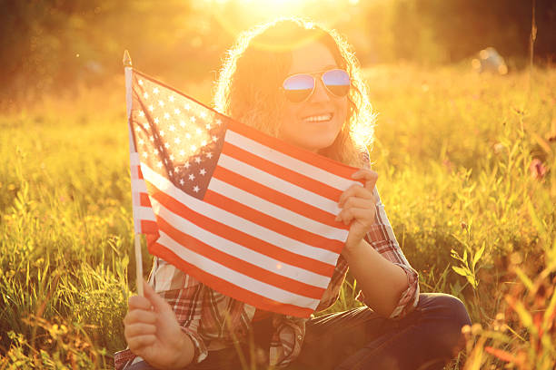 istock beautiful young girl with American flag 518950512