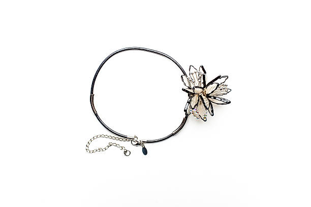istock Necklace on black cord and a decorative flower 518951802