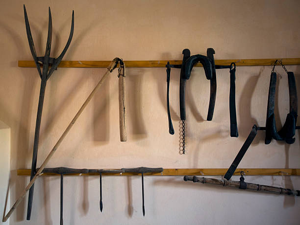 istock Old medieval tool. Historical farm house foundation, saw, drill, flail. 518953054