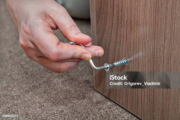 Hex Wrench Allen Key Human Hand Makes Screwed Furniture Screw Stock Photo - Download Image Now