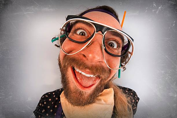 Bearded crazy person lunatic wearing several pairs of glasses