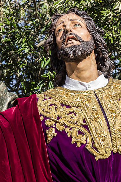 A solemn Sicilian procession in Trapani with life-sized statues on a flower-covered float, depicting Jesus and soldiers. Rich in tradition, devotion, and artistic craftsmanship. A vivid glimpse of Catholic ritual and culture.