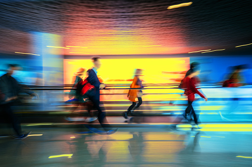Motion-blurred abstract people walking to the airport terminal