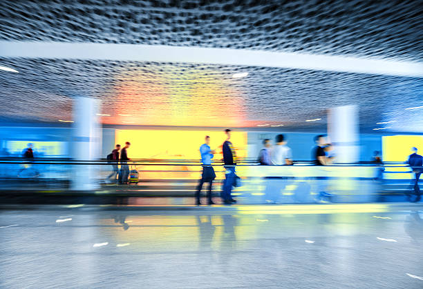 istock Motion-blurred people walking to the airport terminal 518957230