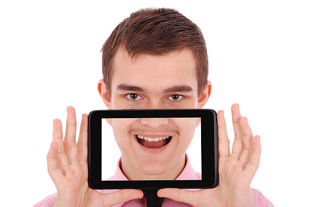 istock Boy in a pink shirt hold a tablet PC 518958942