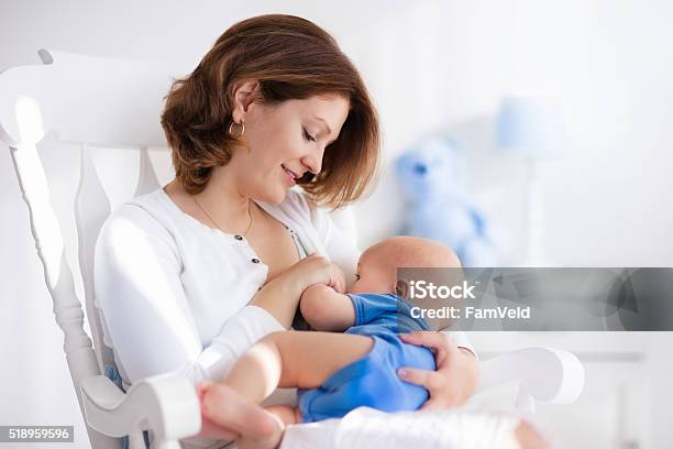 Nice Young Mother With Baby Boy At Home Stock Photo - Download Image Now - Breastfeeding, Mother, Baby - Human Age