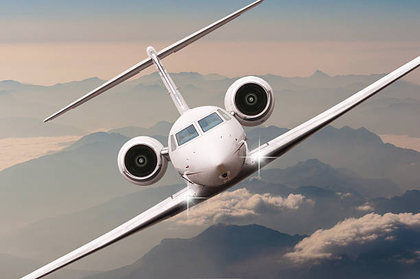 istock Airplane fly over clouds and Alps mountain on sunset. Front 518960042