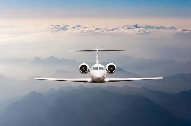 istock Airplane fly over clouds and Alps mountain on sunset. Front 518960088