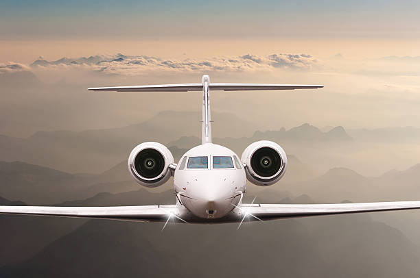 istock Airplane fly over clouds and Alps mountain on sunset. Front 518960116