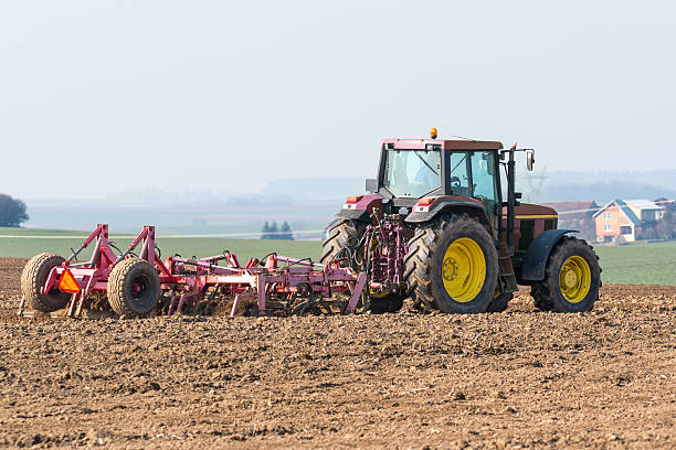 istock Tractor harrowing the field 518963240