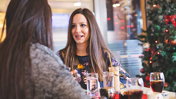 istock Two women sitting in cafe 518963392