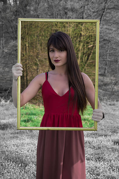 istock Young woman with picture frame 518963644