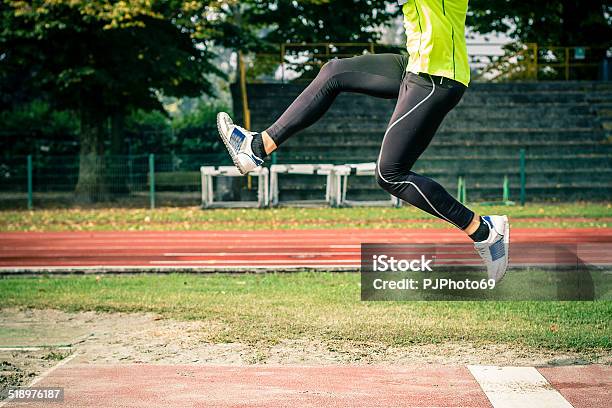 Young Athlete At Long Jump Stock Photo - Download Image Now - Amateur, Track And Field, Triple Jump