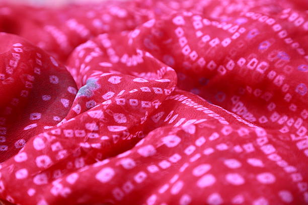 istock Indian bandhej saree cloth fabric texture 518976639