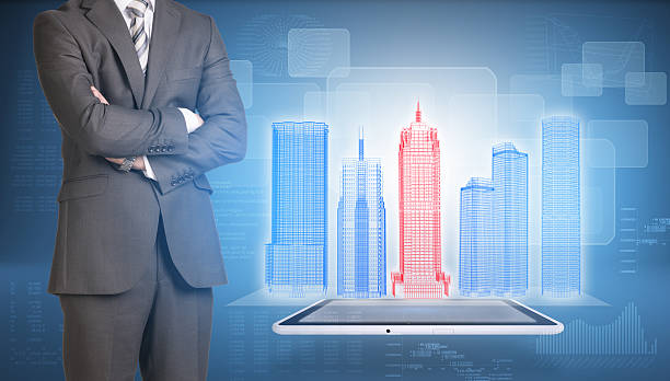 istock Businessman and wire-frame buildings on screen tablet pc 518976665