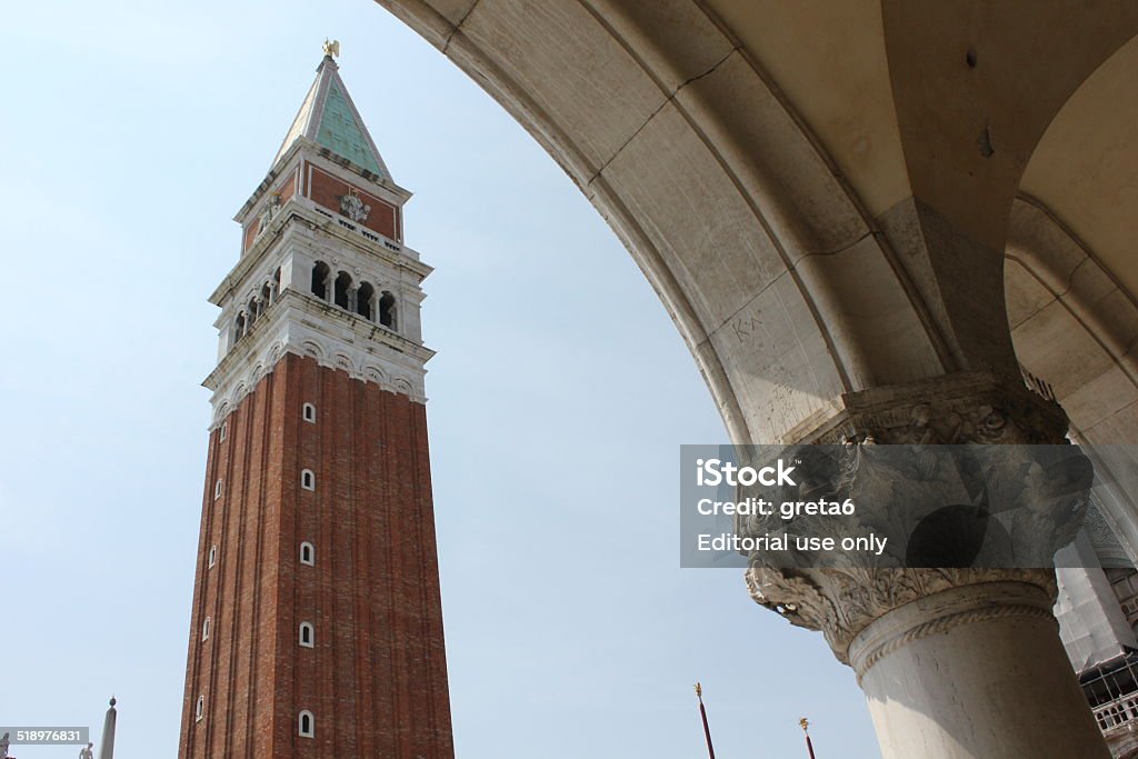 St.Mark Bell tower architectural detail Venice, Italy, June 4 2014: St.Mark Bell tower architectural detail. It is the bell tower of St Mark's Basilica in Venice, Italy, located in the Piazza San Marco. It is one of the most recognizable symbols of the city. Architecture Stock Photo