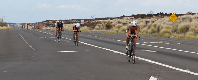 Kona, Hawaii, USA - October 11, 2014:  Ironman athletes during the return bike portion of the annual Kona Ironman triathalon.