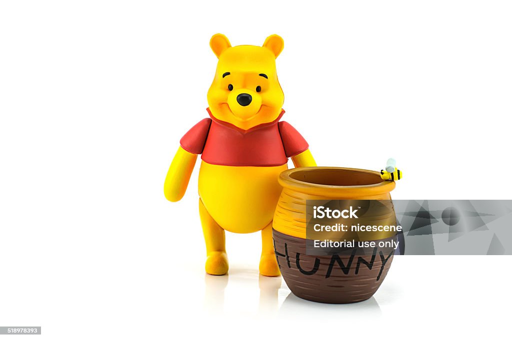 Figure of Winnie the Pooh and hunny pot. Bangkok, Thailand - July 28, 2014 : Figure of Winnie the Pooh and hunny pot. Winnine the Pooh is animation from Disney. Winnie The Pooh Stock Photo
