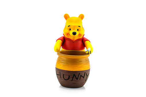 Bangkok, Thailand - July 28, 2014 : Figure of Winnie the Pooh and hunny pot. Winnie the Pooh is animation from Disney.