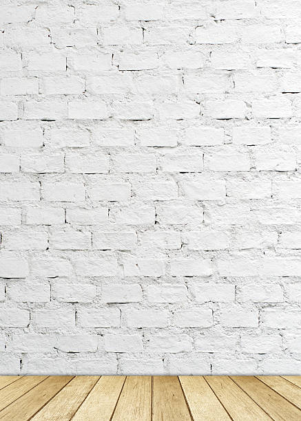 istock White brick wall and wood floor, empty perspective room. 518978681