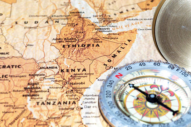 Travel destination Kenya, Ethiopia, Somalia: ancient map with vintage compass Compass on a map pointing at Kenya, Ethiopia and Somalia, planning a travel destination ethiopia city stock pictures, royalty-free photos & images
